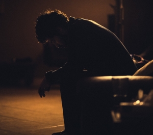 Student sitting alone in dark