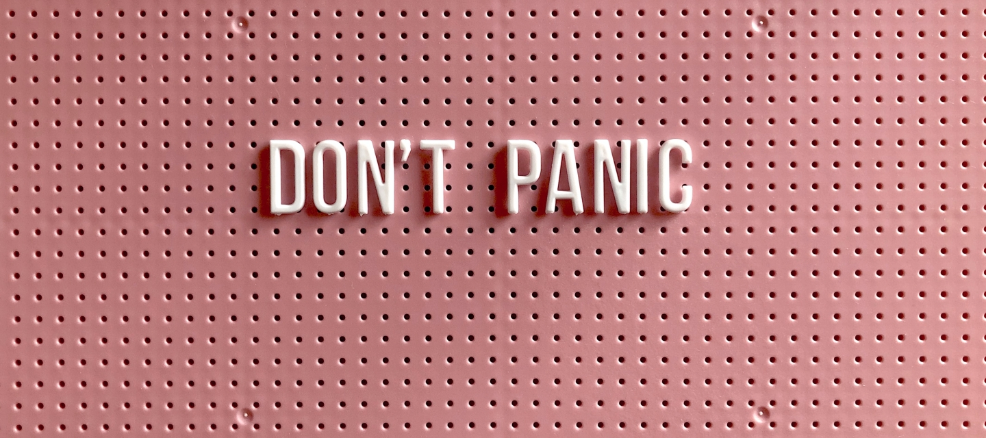 Push pin letters that spell "Dont' panic"