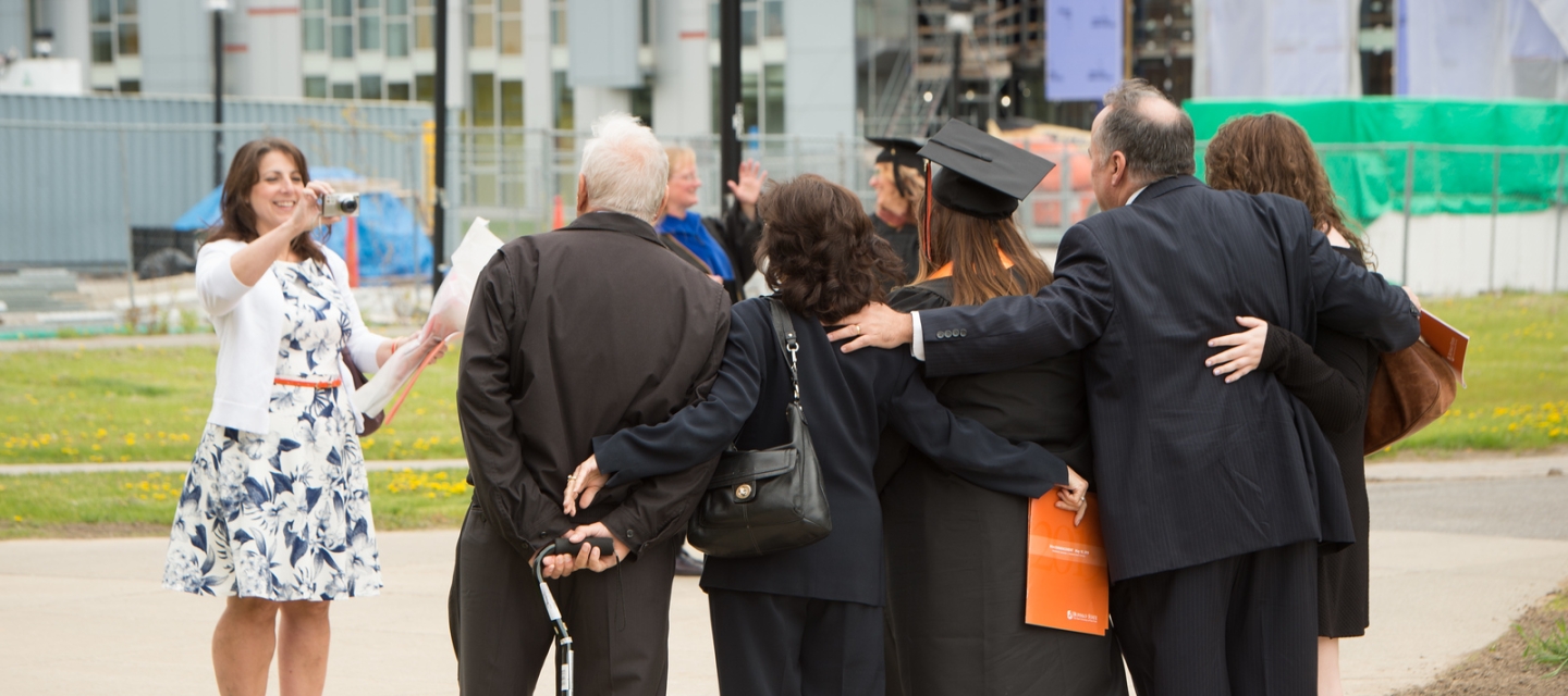 Family at commencement posing for photo 